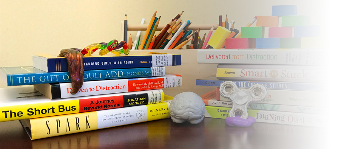 Various ADHD/LD books, resources, and fidget objects.